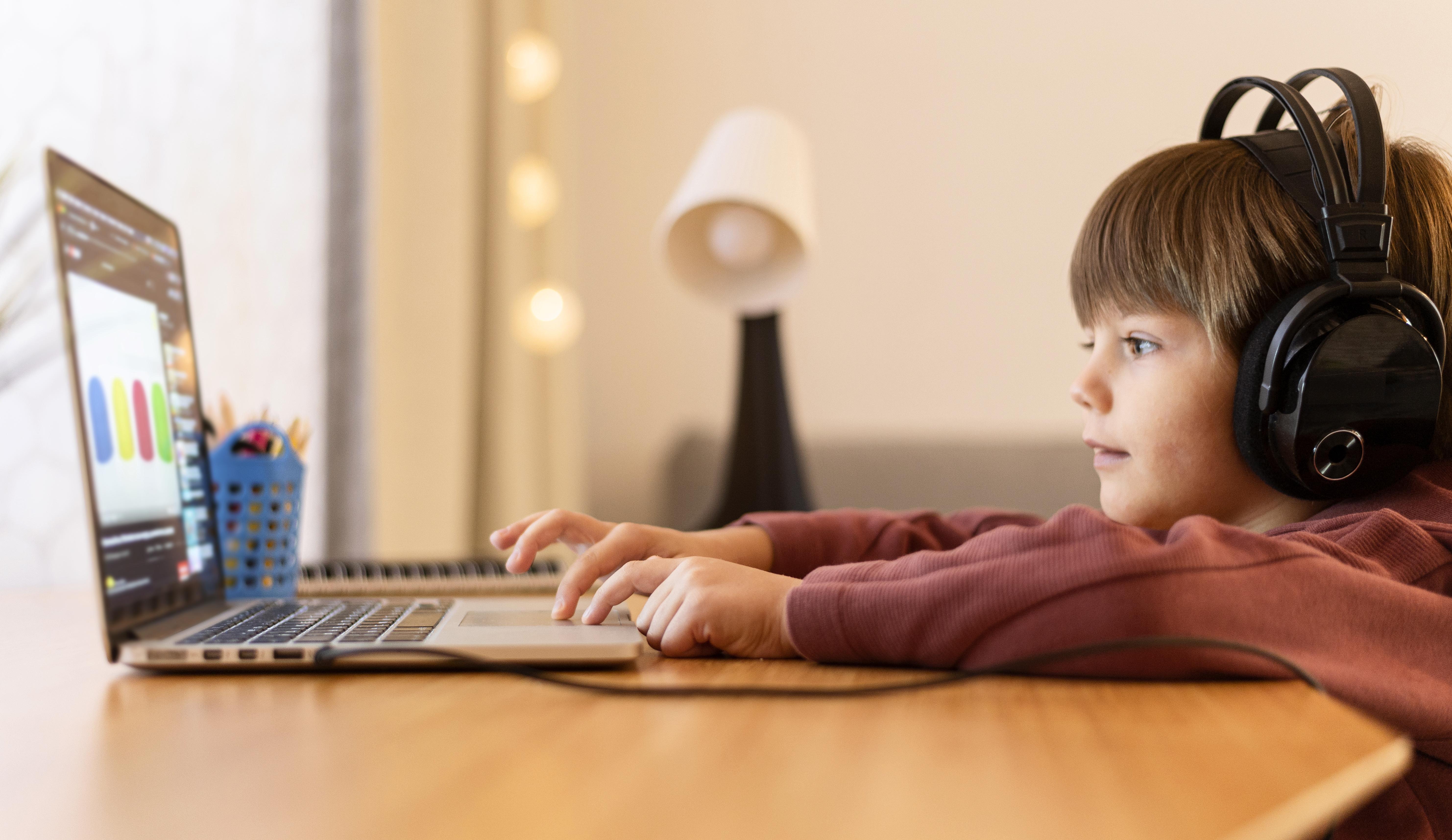 Young learner confidently coding on a laptop