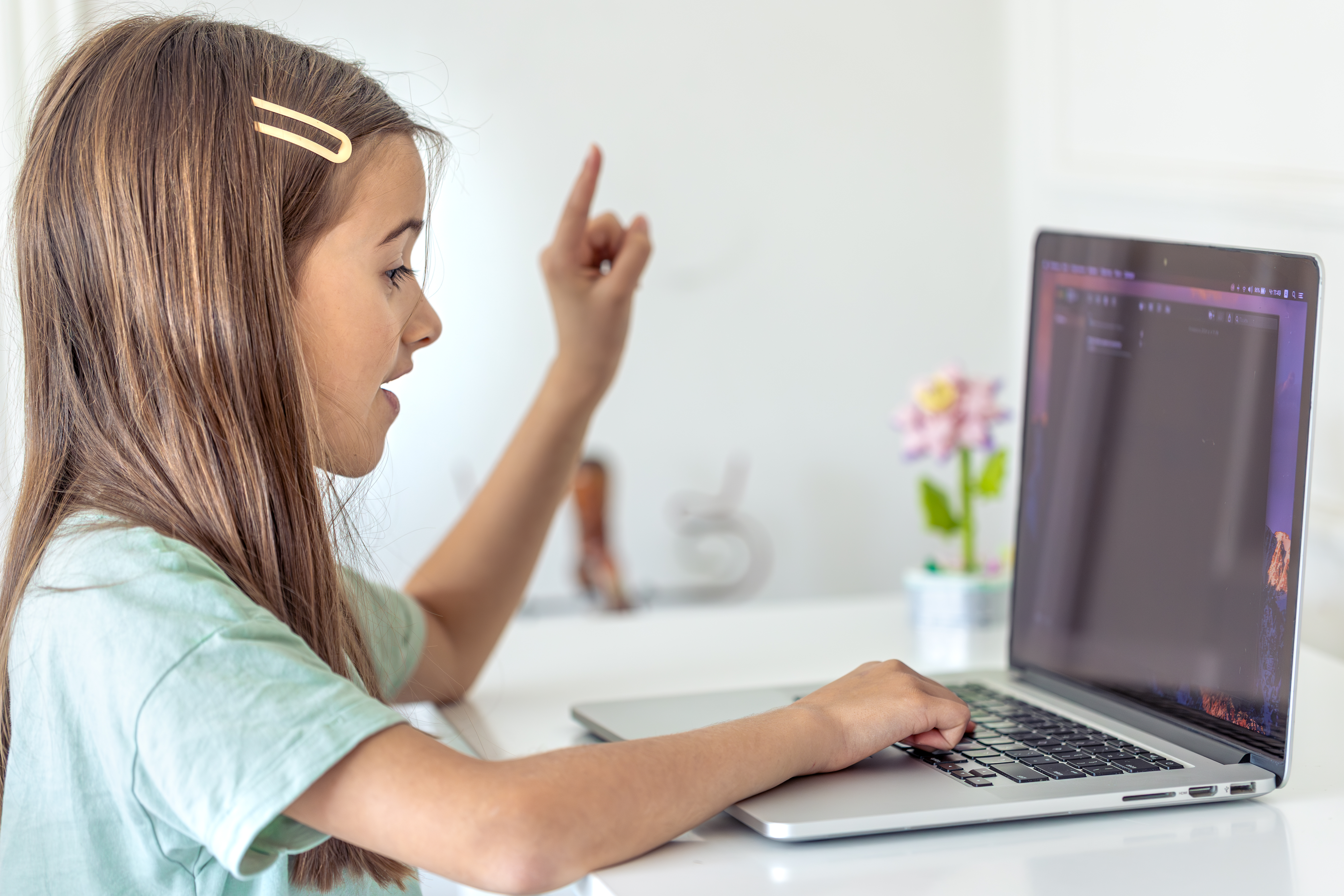 Child coding from home with a laptop